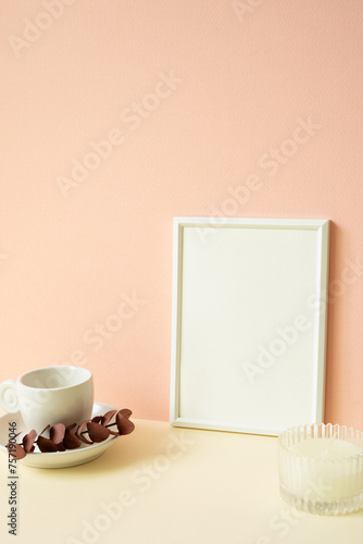Obraz na płótnie White blank picture frame with coffee cup, candle on ivory table. pink wall background w salonie
