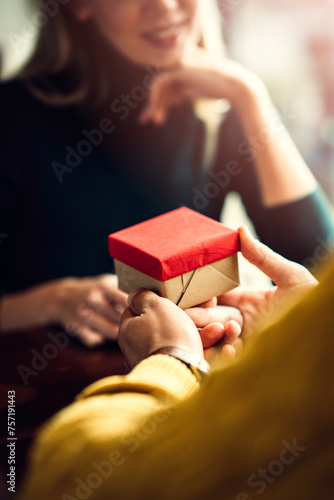 a young couple celebrating in a caffee, with gifts © kerkezz