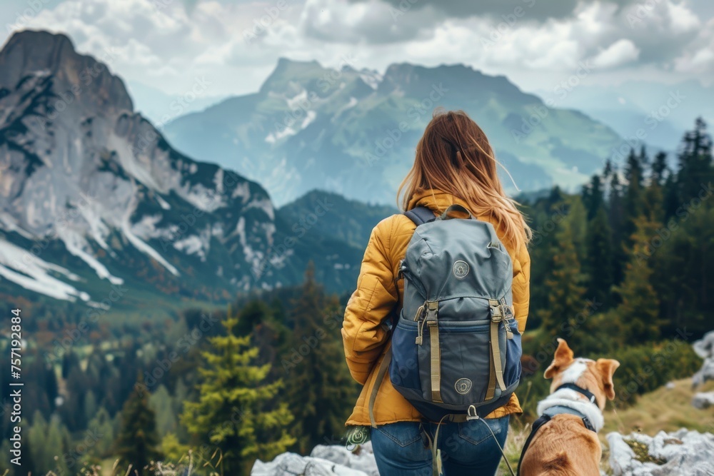 Backpack travel woman with dog in nature mountains trip.