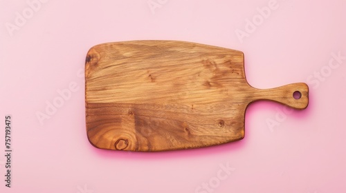 A wooden cutting board rests elegantly on a soft pink background