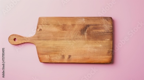 A wooden cutting board rests elegantly on a vibrant pink background
