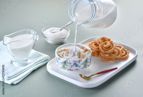 Jalebi with milk, unsweetened jalebi is used in Ramadan with warm milk and sugar. It is healthy and delicious meal. photo