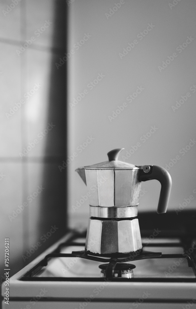 A small metal coffe percolater on the stove in the kitchen. Moka pot. Coffee maker. A small metal coffe percolater on the stove in the kitchen. Moka pot. Coffee maker.