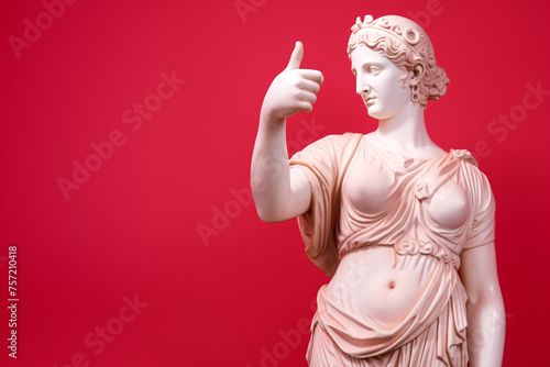 Ancient Gypsum Statue Giving Thumbs Up Against Red Background