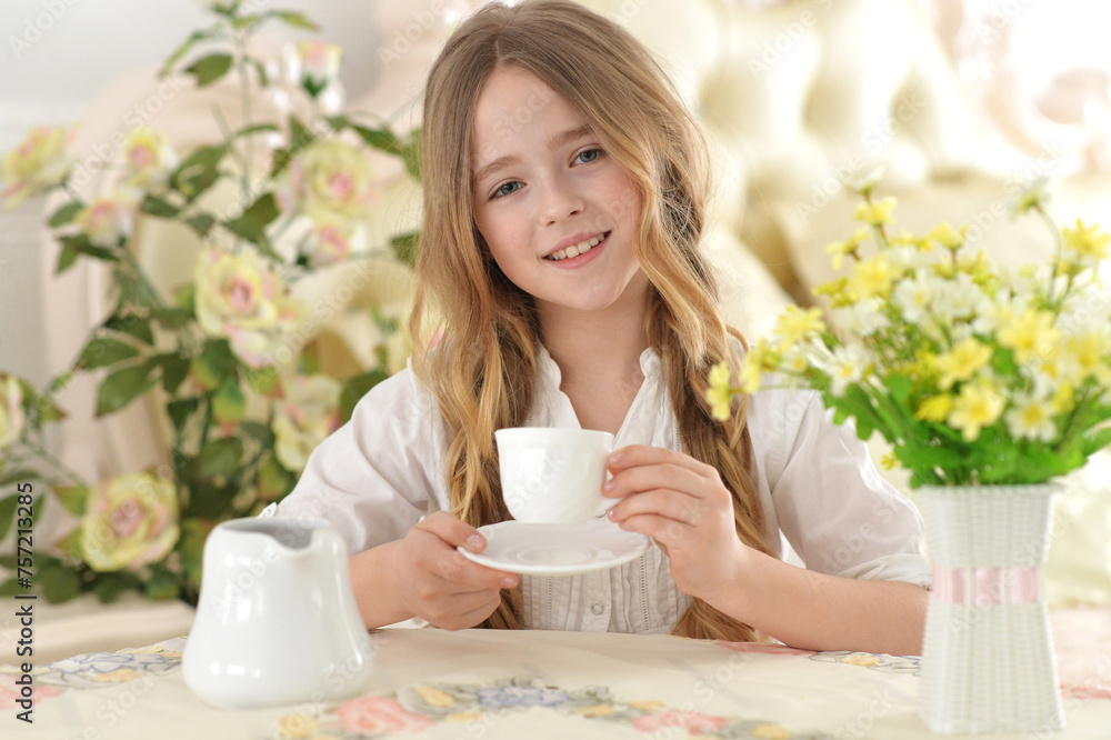 Smiling little girl holding big cup of tea Smiling little girl holding big cup of tea