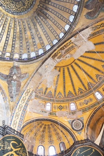 ISTANBUL,TURKEY,SEPTEMBER 26, 2023: Close-up of the dome of the Hagia Sophia with a mosaic of sails, seraphim angels, large round medallions  photo