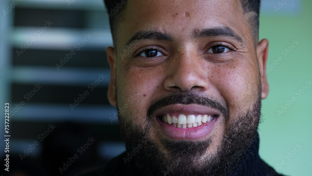 One happy latin South American young man looking at camera smiling. Tight close-up face of 20s millennial person One happy latin South American young man looking at camera smiling. Tight close-up face of 20s millennial person