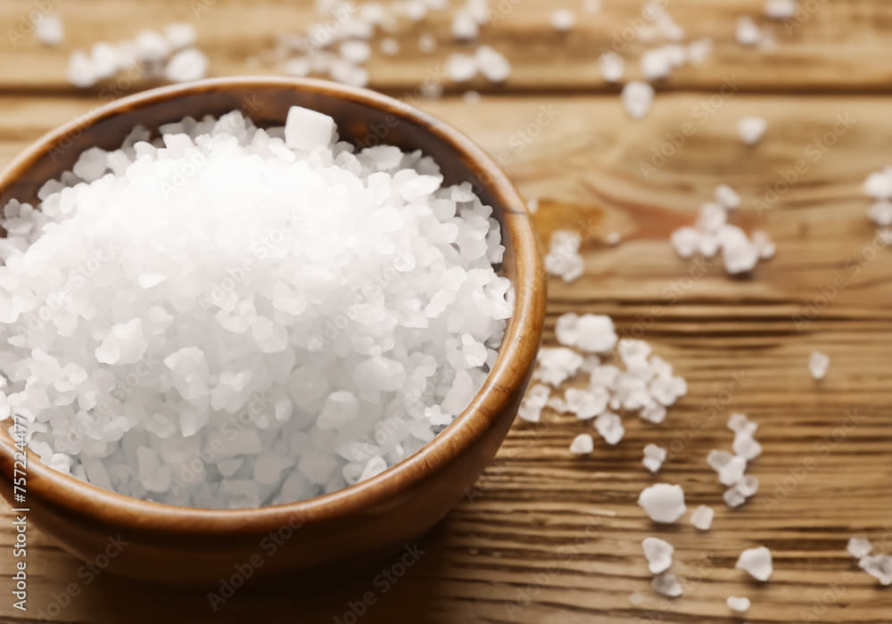 sea salt in bowl on wooden background sea salt in bowl on wooden background