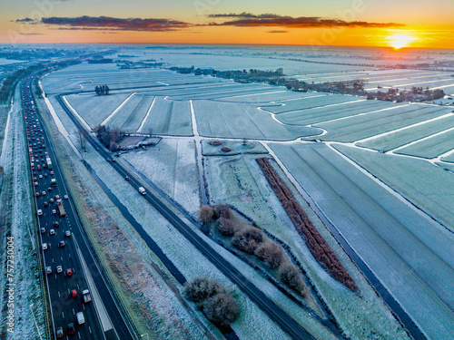Winter sunrise over a frostcovered landscape with busy morning commute. photo