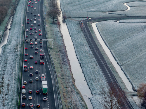 A winter commute with frostcovered fields and a busy highway