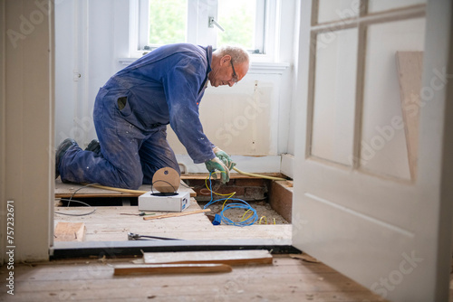Senior workman involved in a home renovation project. photo