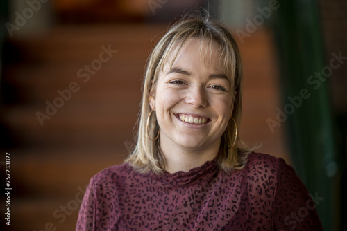 Young woman smiling brightly indoors photo