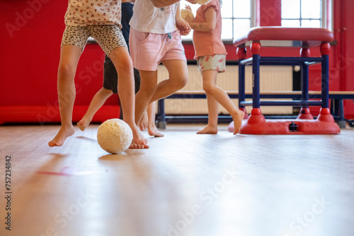 Children playing a game indoors with a ball photo