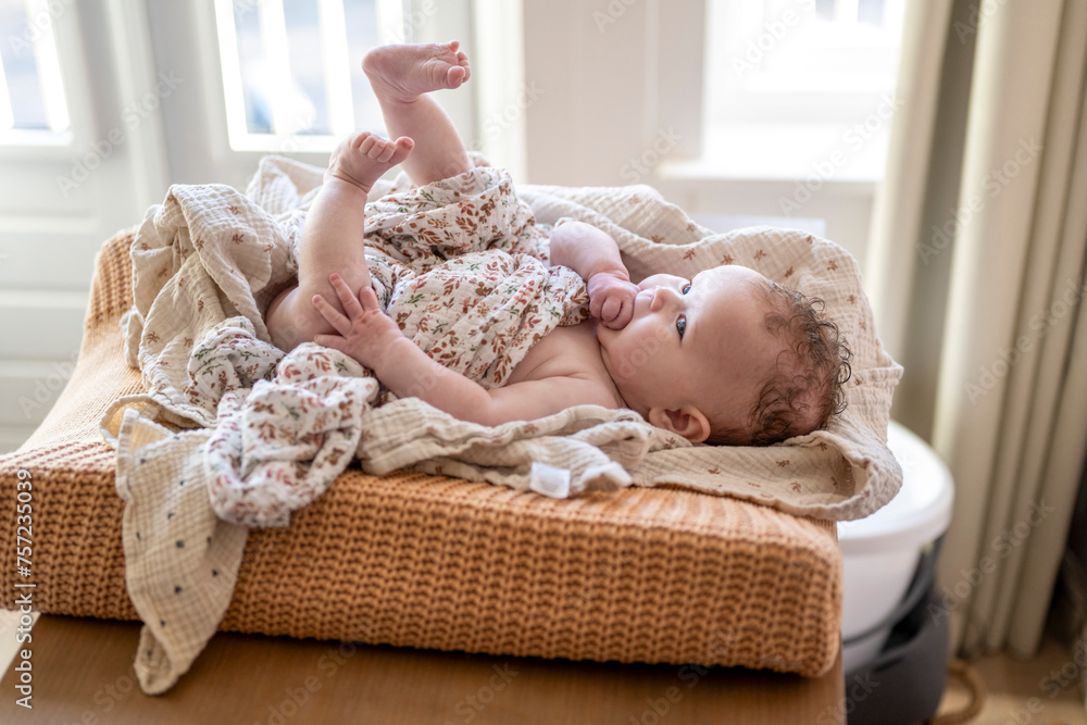 © Connect Images - Baby lying comfortably on a woven basket at home