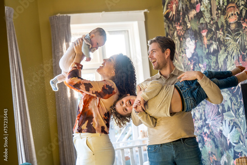 Joyful family playing together in a vibrantly decorated room photo