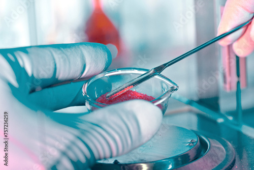 Scientist conducting a lab experiment with a petri dish photo