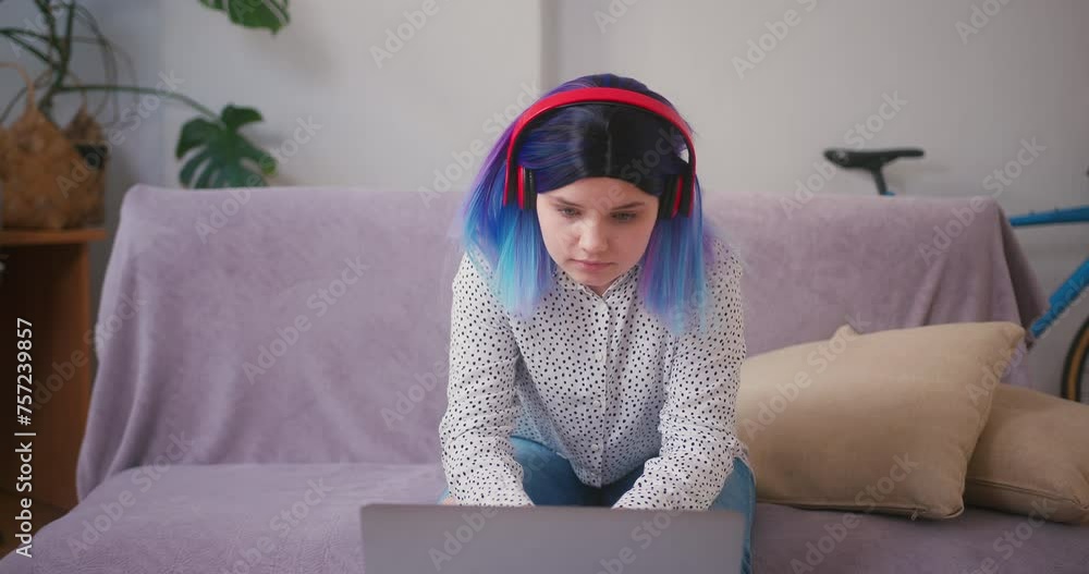 Young latin hispanic teenager girl typing on laptop keyboard sit at ...