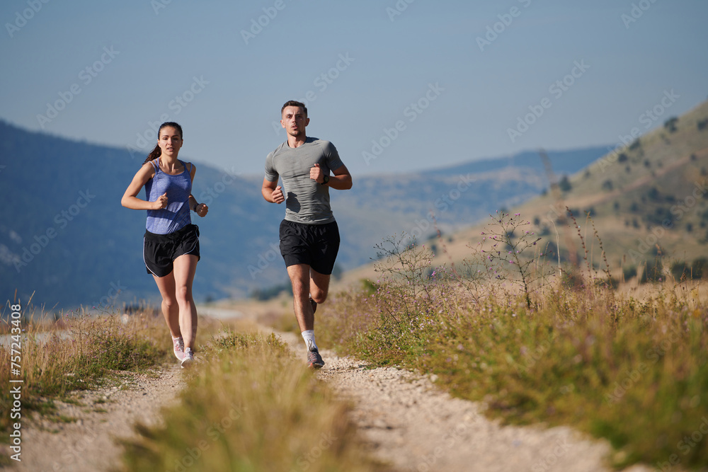 Energized by the beauty of nature, a couple powers through their morning run, their bodies and spirits invigorated. Energized by the beauty of nature, a couple powers through their morning run, their bodies and spirits invigorated.