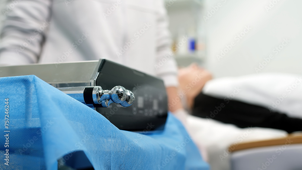 Beautiful woman receiving facial microcurrent treatment at spa salon