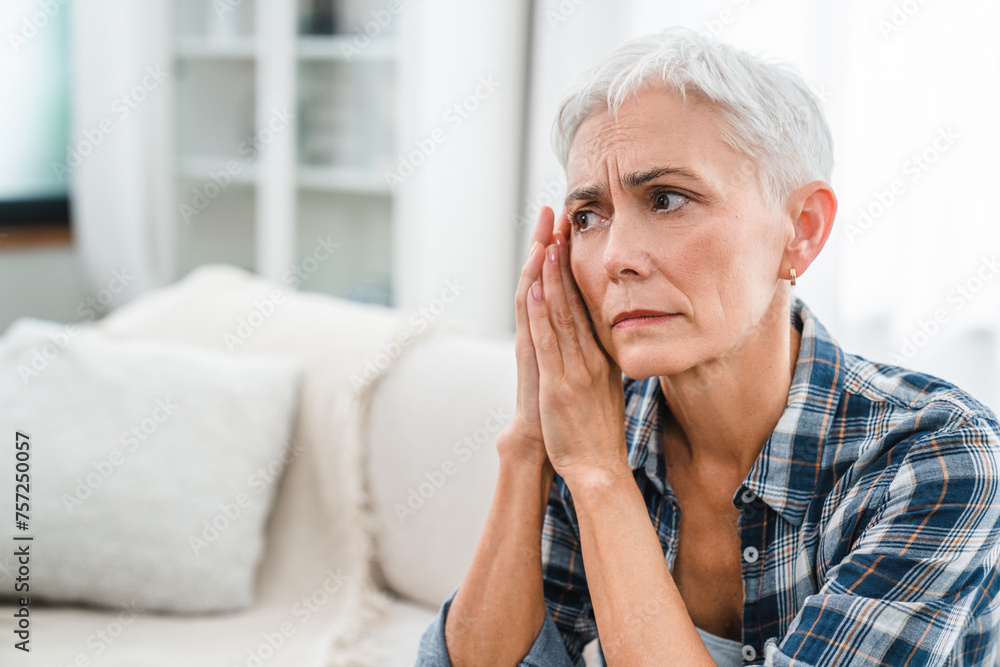 Depressed Caucasian mature woman suffering from pain ache at home. Exhausted middle-aged housewife having menopause, period cramps, depression, breakup, severe grief Depressed Caucasian mature woman suffering from pain ache at home. Exhausted middle-aged housewife having menopause, period cramps, depression, breakup, severe grief