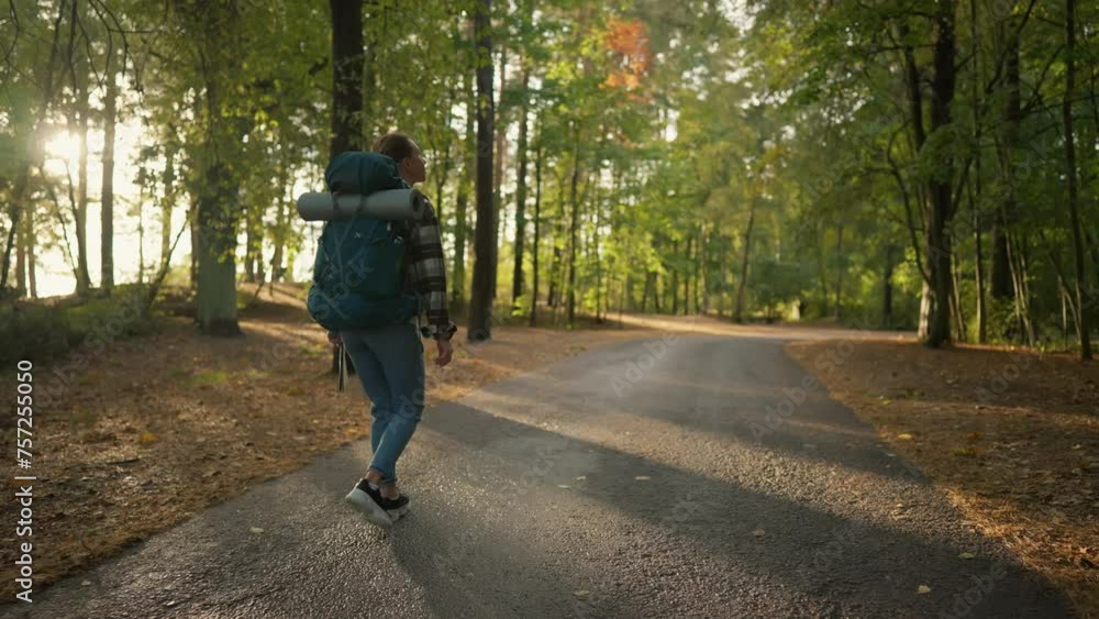 Woman tourist walks on sandy sea beach. Female traveler carrying big backpack with touristic equipment. Hiker enjoying admiring nature. Travel tourism trip vacations outdoors activity concept. Woman tourist walks on sandy sea beach. Female traveler carrying big backpack with touristic equipment. Hiker enjoying admiring nature. Travel tourism trip vacations outdoors activity concept.