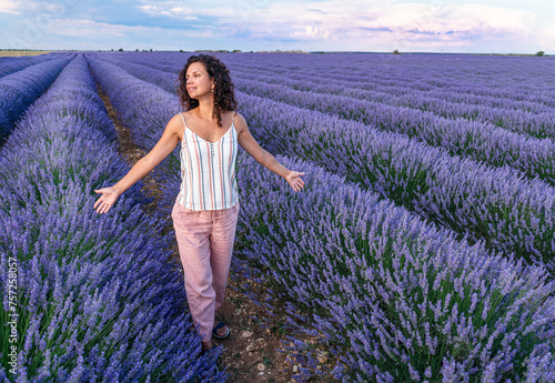 Wallpaper Mural Woman walking in the lavender field. Cloudy sky at the background. Brihuega, Spain. Torontodigital.ca