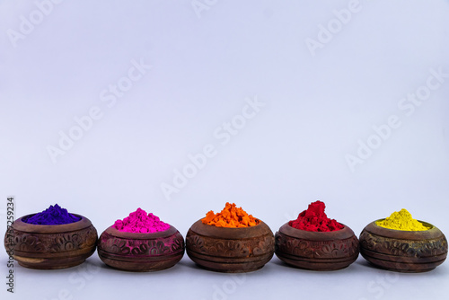 Gulal colors in wooden pots for celebrating Holi festival.