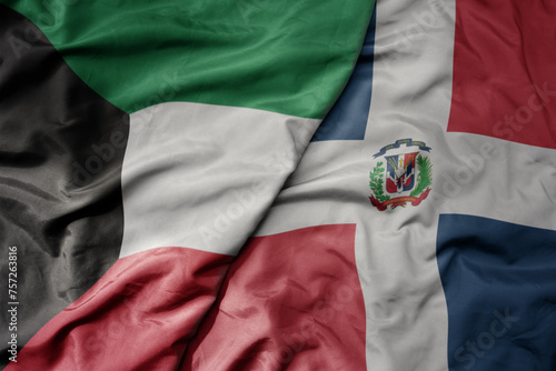 big waving national colorful flag of dominican republic and national flag of kuwait.