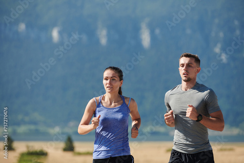 Energized by the beauty of nature, a couple powers through their morning run, their bodies and spirits invigorated. © .shock