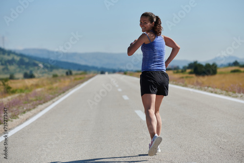 A determined woman athlete trains for success in the morning sun.