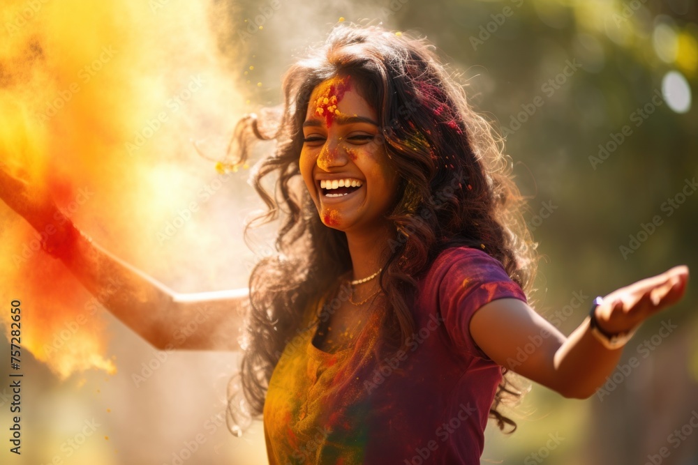 Exuberant woman at Holi festival with colorful powder cloud