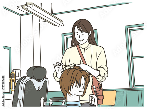 ヘアマネキンでカット練習をする女性美容師