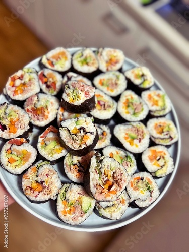 homemade sushi, colorful sushi rings, rice, algae dish, vegetables and tuna, smoked salmon