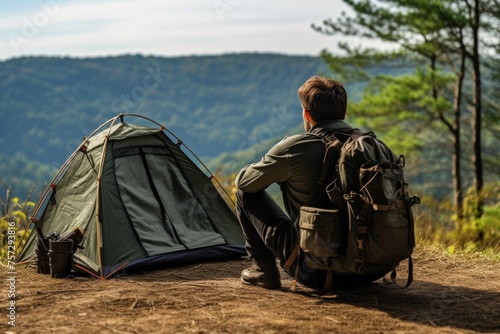 Man sitting by tent in beautiful natural setting, copy space for text, camping adventure concept