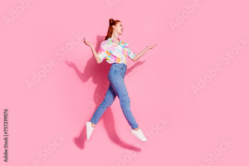 Full body size photo of red hair curly hair hipster lady jump trampoline raised arms up look novelty isolated on pink color background © deagreez