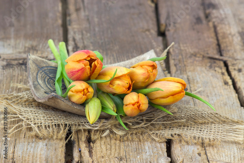 yellow tulips on wooden background - close up