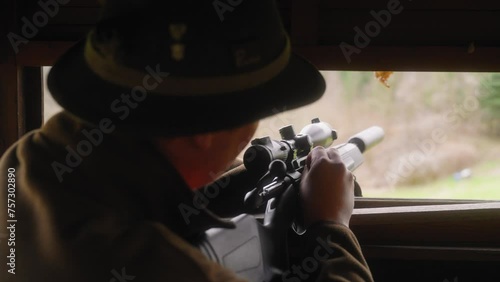 hunter loading bullet into hunting rifle and aiming