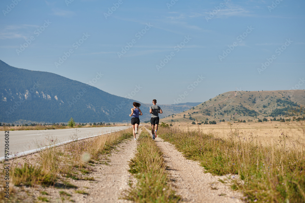 Energized by the beauty of nature, a couple powers through their morning run, their bodies and spirits invigorated.