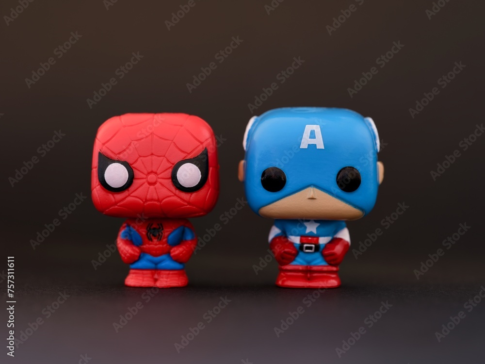 Naklejka premium Tambov, Russian Federation - January 07, 2024 Two Marvel Funko POP Mini Vinyl Figures - Spider-Man and Captain America on a black background.