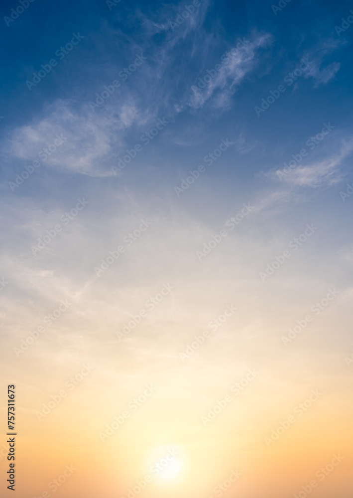 Sunset sky clouds vertical in the evening summer with orange, yellow sunlight in golden hour or morning sunrise