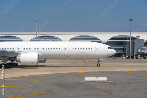 Taxiing commercial airliner nose engine portholes, ready for departure background terminal