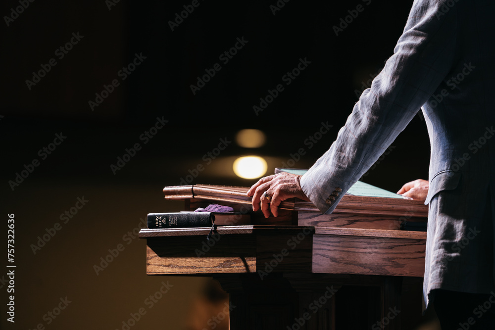 Naklejka premium Pastor with hands on pulpit, Preacher Preaching