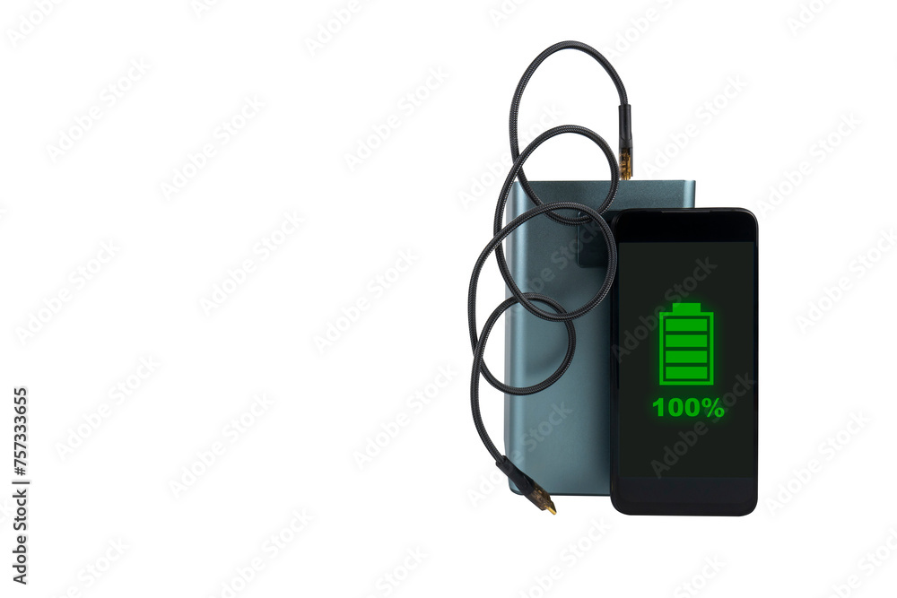 A smartphone next to a large power bank (charging station) with a USB cable on a transparent background. On the smartphone screen there is a green indicator of 100% battery charge (full charge) A smartphone next to a large power bank (charging station) with a USB cable on a transparent background. On the smartphone screen there is a green indicator of 100% battery charge (full charge)