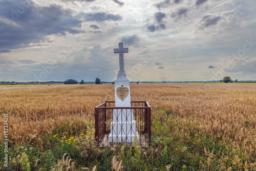Wayside shrine on a field in Wegrow County, rural area of Mazowsze region in Poland photo