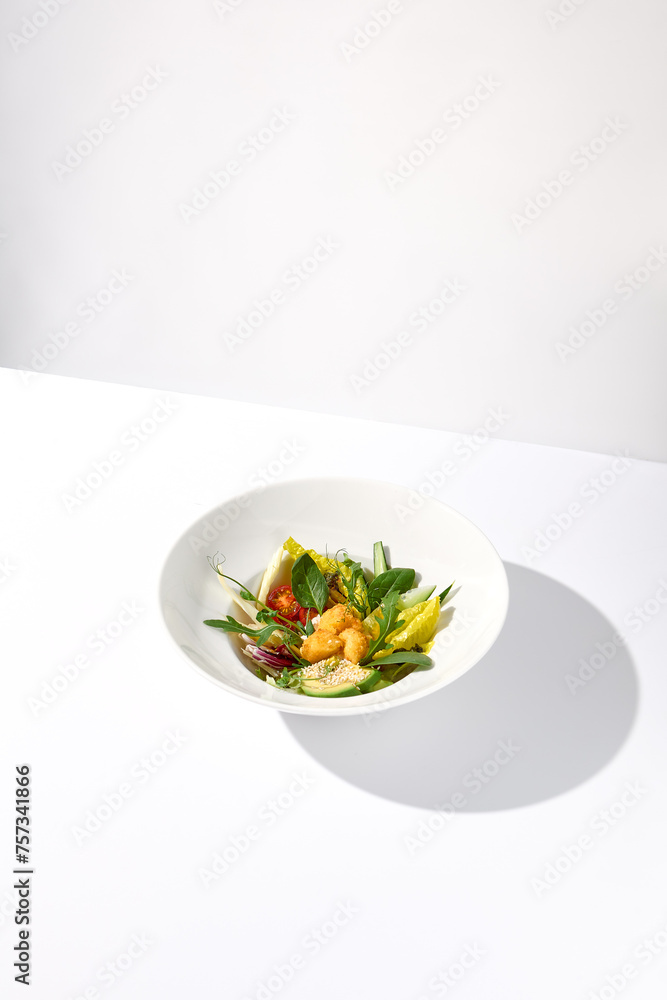 Vegetable salad bowl with avocado and cheese tempura balls on an isolated white background Vegetable salad bowl with avocado and cheese tempura balls on an isolated white background