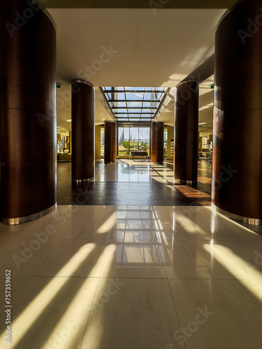 Hotel entrance or lobby with natural light and a piano.