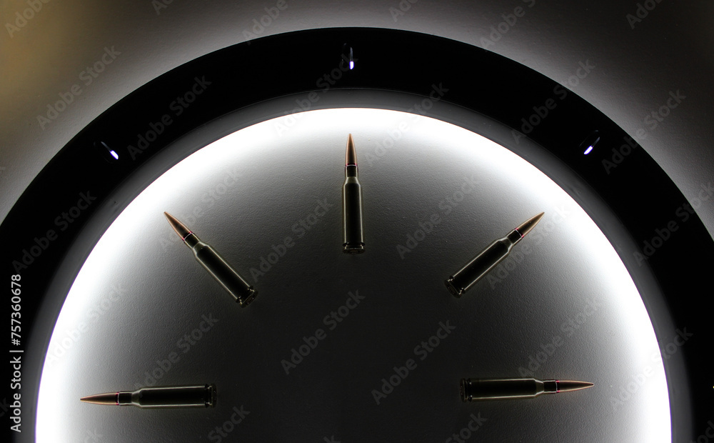 Top part of classic clock dial made of bullets inside a circle of light ...