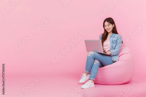 Full body young happy young woman of Asian ethnicity sit in bag
