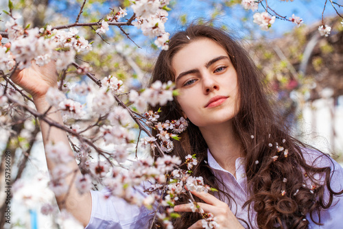 Young beautiful woman in a blooming garden