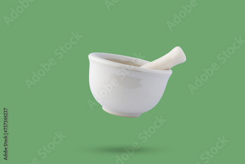 Cuadro en lienzo White mortar and pestle isolated on green background